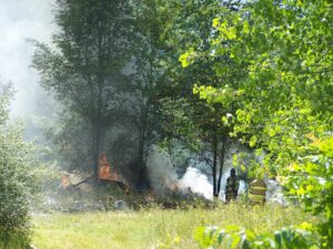 Water and foam are being used to put out a trash fire east of Warsaw. (Photo by Stacey Page)